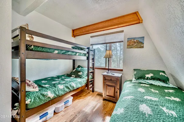 a view of a bedroom with furniture and flat screen tv