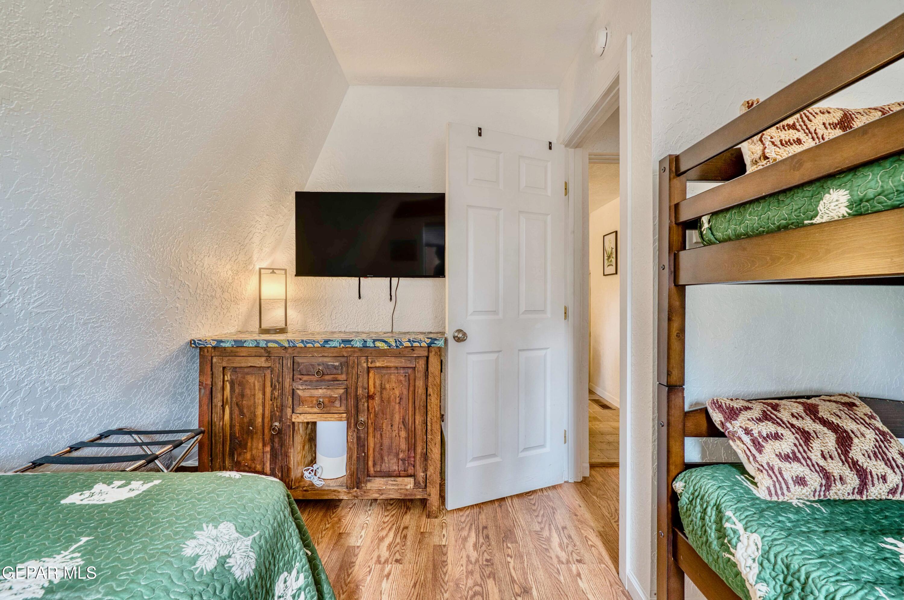 104 Meadow Wood Ruidoso, NM 88345 - Photo 33 of 55 a view of a bedroom with furniture and flat screen tv