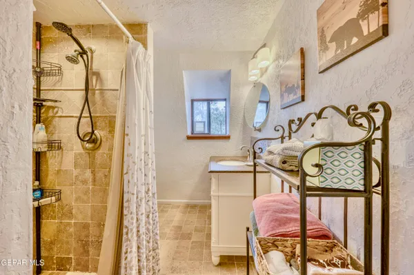 a bathroom with a granite countertop sink and a mirror