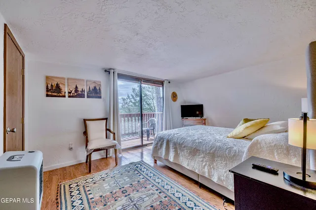 a bedroom with a large bed and a large window