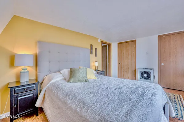 a bedroom with two beds and a desk