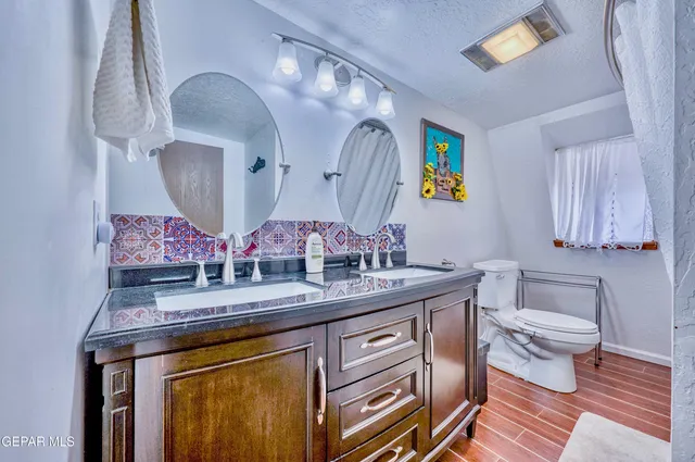 a bathroom with a sink mirror and vanity