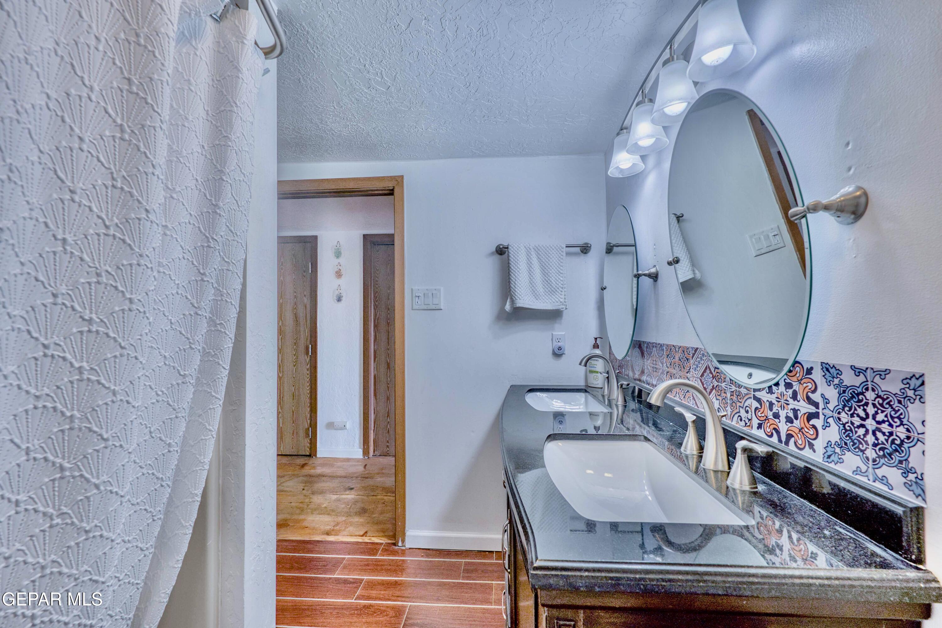 104 Meadow Wood Ruidoso, NM 88345 - Photo 50 of 55 a bathroom with a sink and a mirror