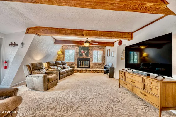 a living room with furniture a ceiling fan and a rug