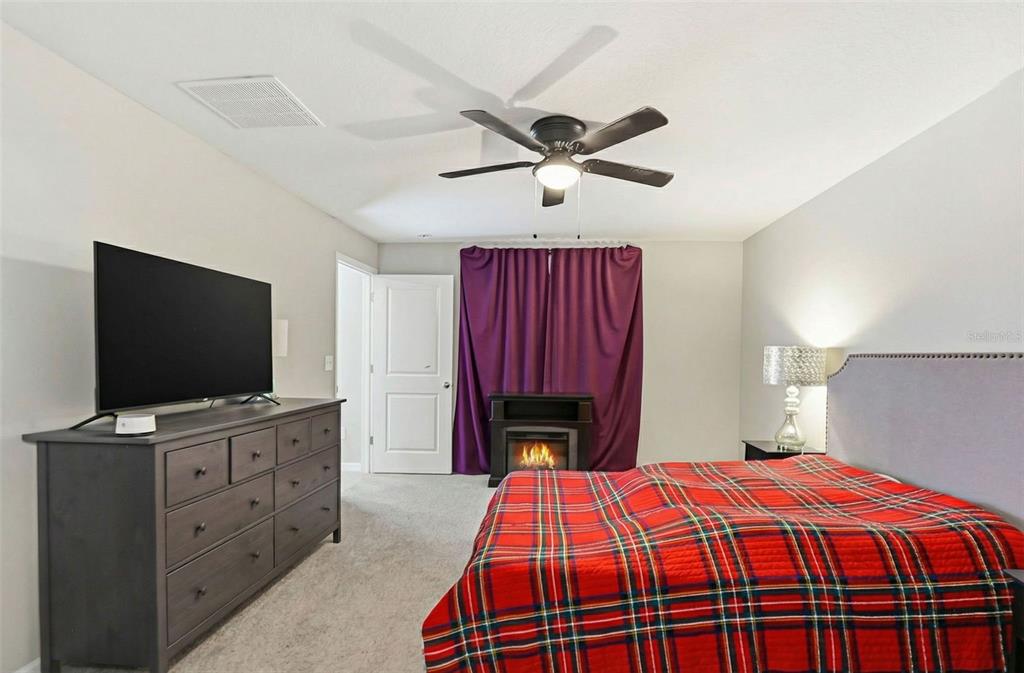 211 English Channel Place Dover, FL 33527 - Photo 16 of 35 a bedroom with a bed and a flat screen tv