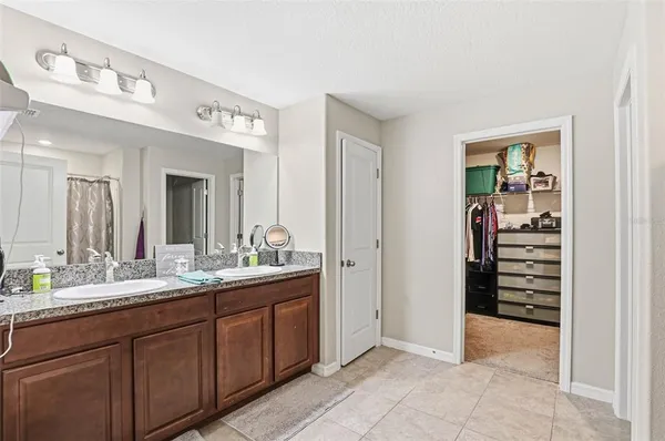 a spacious bathroom with a granite countertop sink and a mirror
