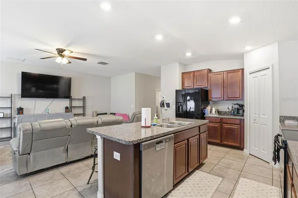 a kitchen with a stove a sink and a refrigerator