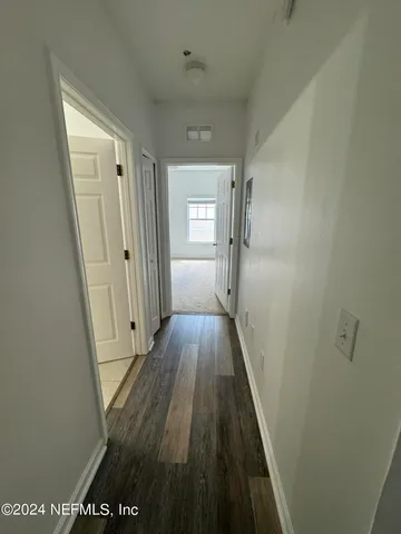 a view of hallway with wooden floor