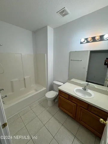 a bathroom with a sink a toilet and bathtub