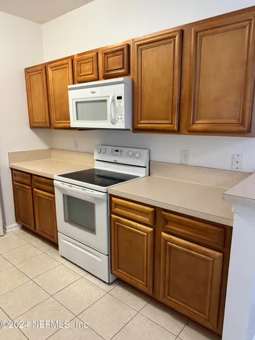 a kitchen with stainless steel appliances granite countertop a sink stove and microwave