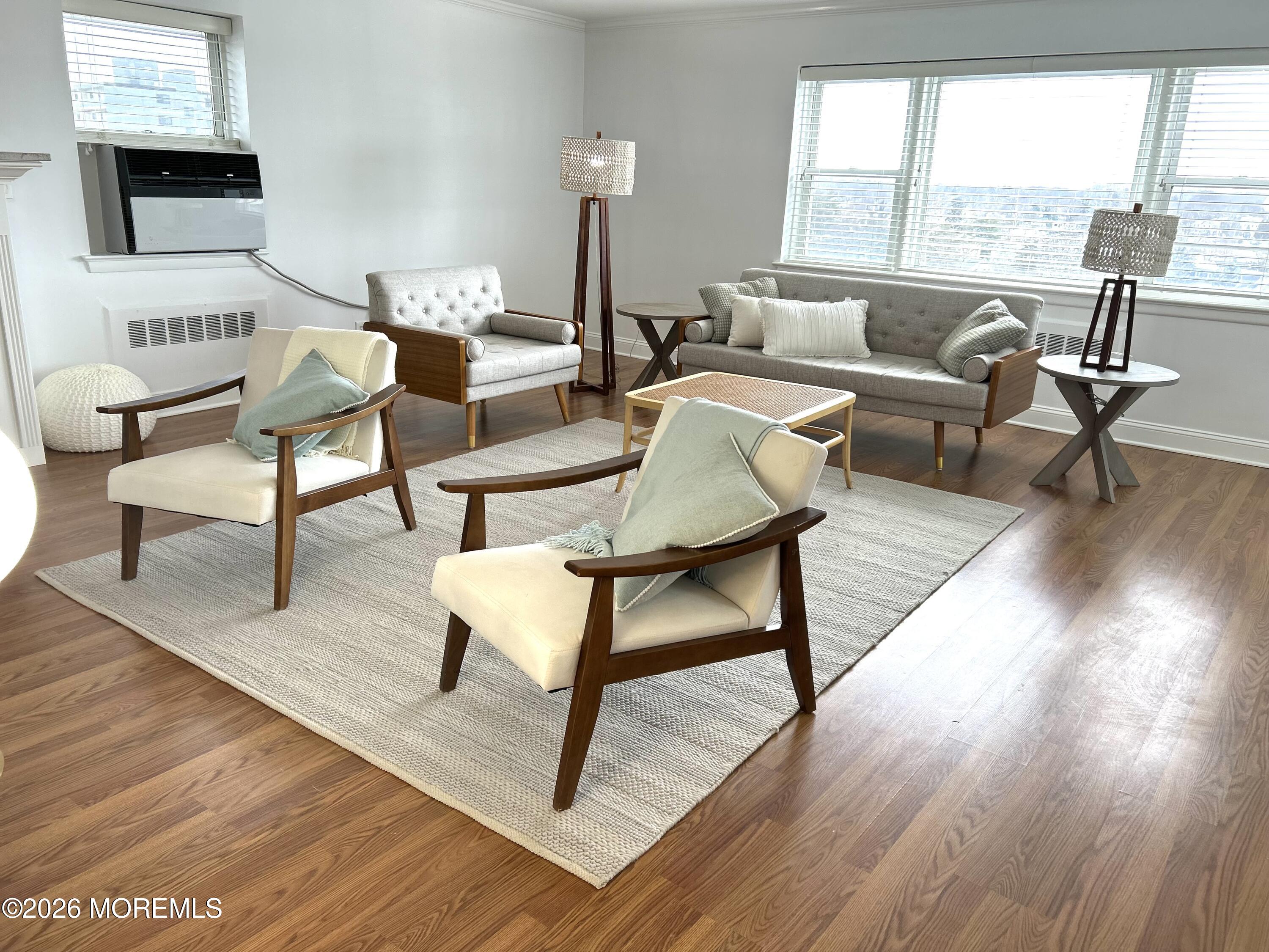 122 Bodman Place, Unit PHA Red Bank, NJ 07701 - Photo 12 of 23 a living room with furniture and a flat screen tv with wooden floor