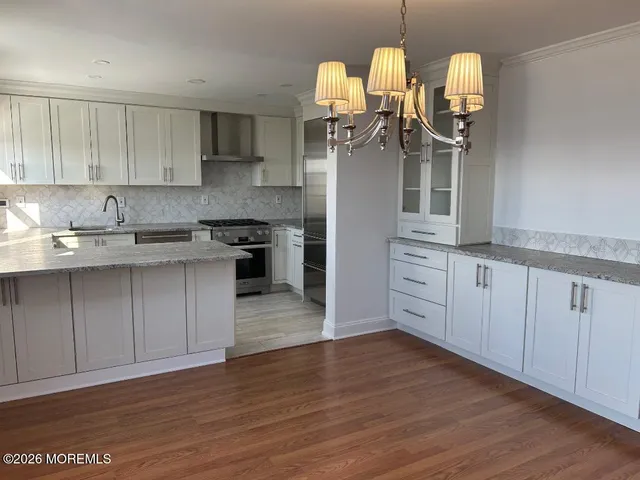 a kitchen with granite countertop sink and cabinets