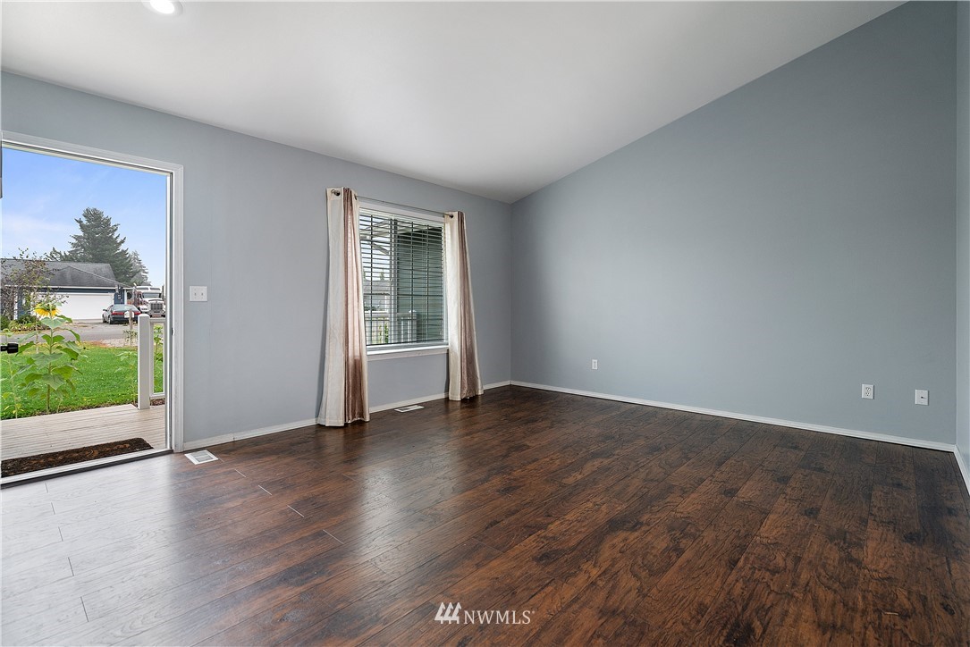 18011 Daryl Lane Southwest Rochester, WA 98579 - Photo 11 of 31 an empty room with wooden floor and windows