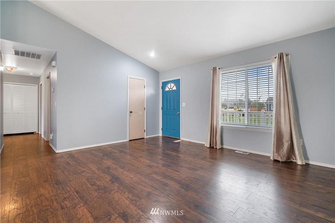 18011 Daryl Lane Southwest Rochester, WA 98579 - Photo 12 of 31 an empty room with wooden floor and windows