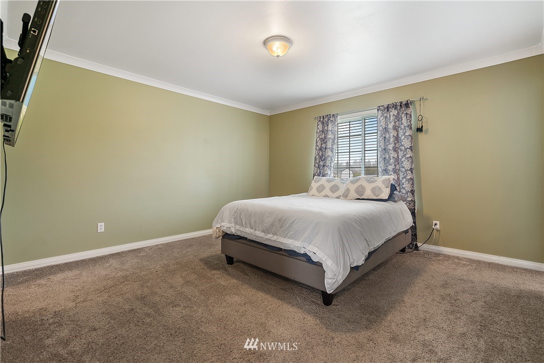 18011 Daryl Lane Southwest Rochester, WA 98579 - Photo 20 of 31 a bed sitting in a spacious bedroom next to a window