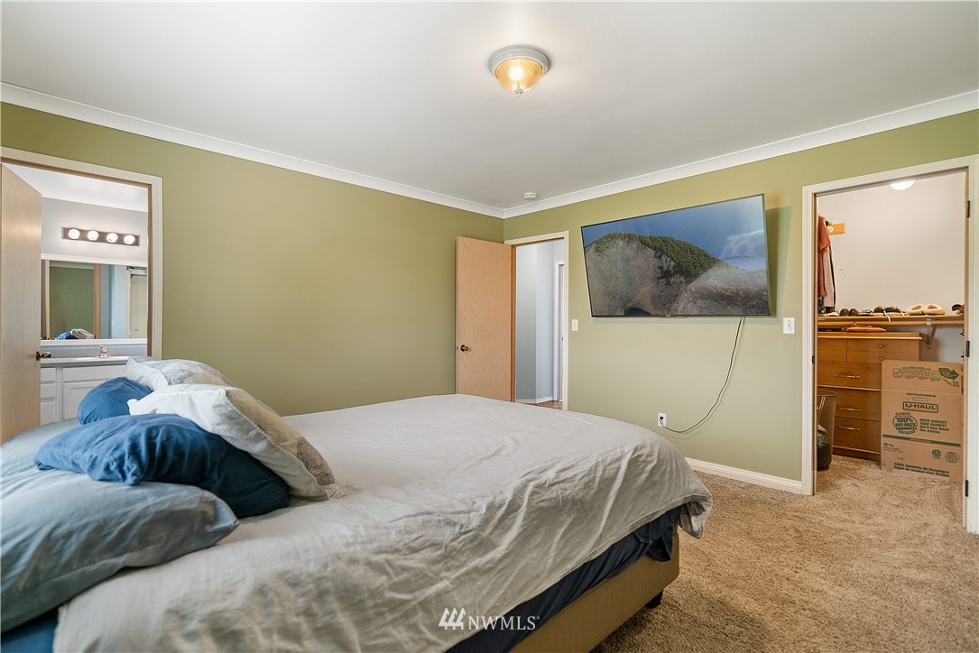 18011 Daryl Lane Southwest Rochester, WA 98579 - Photo 21 of 31 a bedroom with a bed and a walk in closet