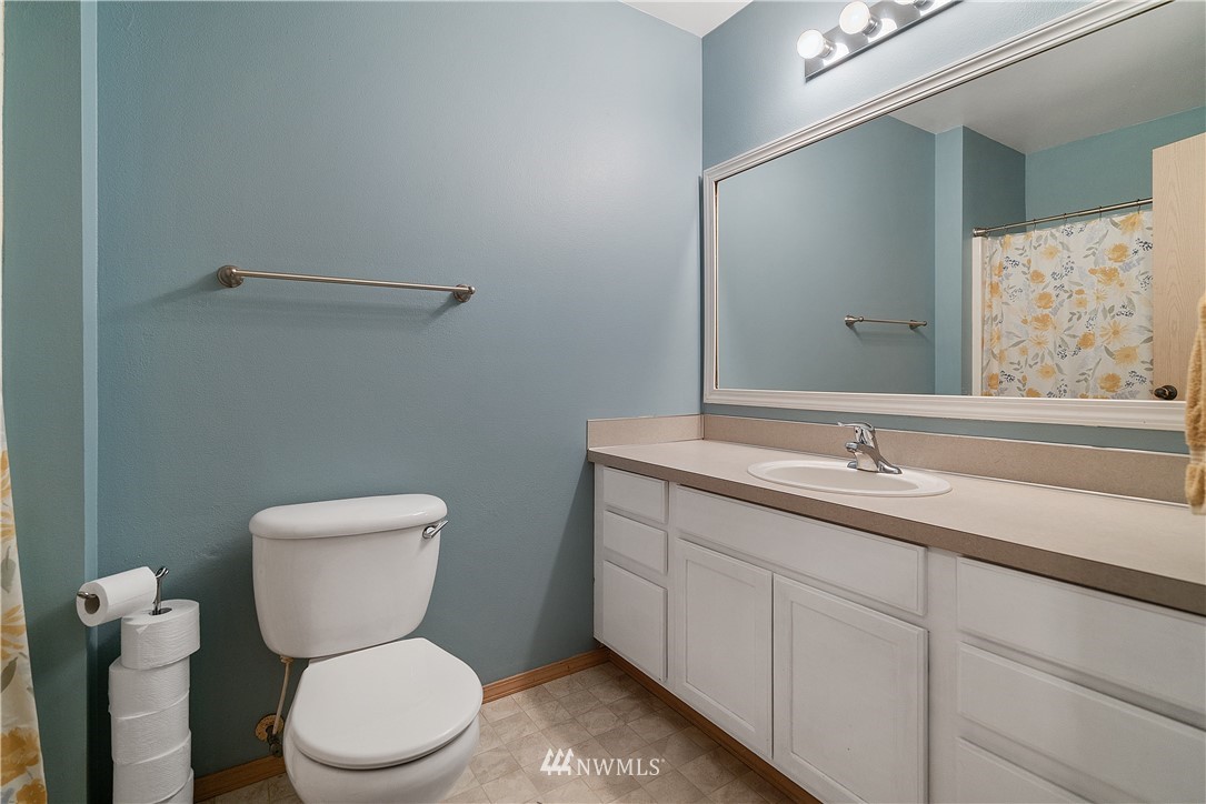 18011 Daryl Lane Southwest Rochester, WA 98579 - Photo 23 of 31 a bathroom with a toilet sink and mirror