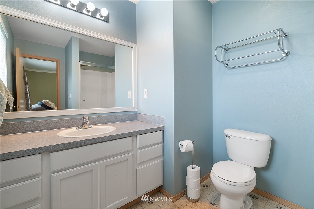18011 Daryl Lane Southwest Rochester, WA 98579 - Photo 24 of 31 a bathroom with a granite countertop toilet sink and mirror