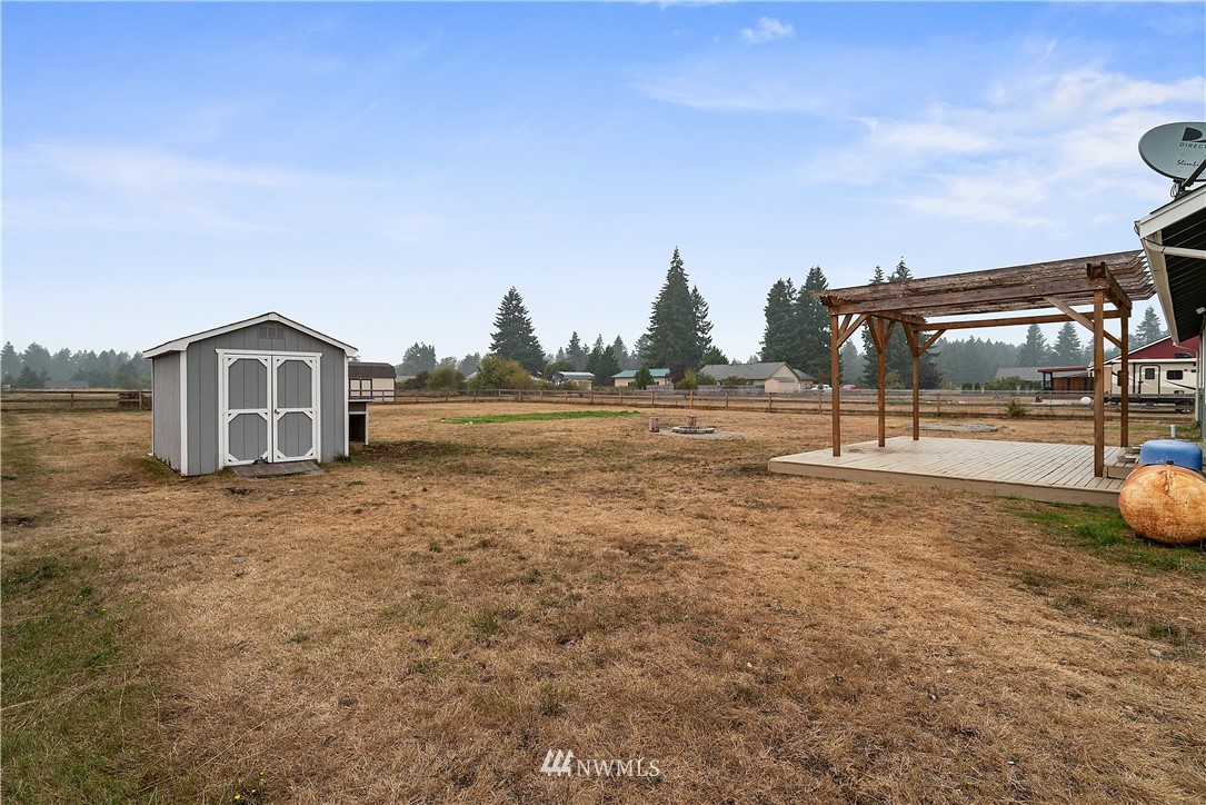 18011 Daryl Lane Southwest Rochester, WA 98579 - Photo 28 of 31 a view of a house with backyard and sitting area