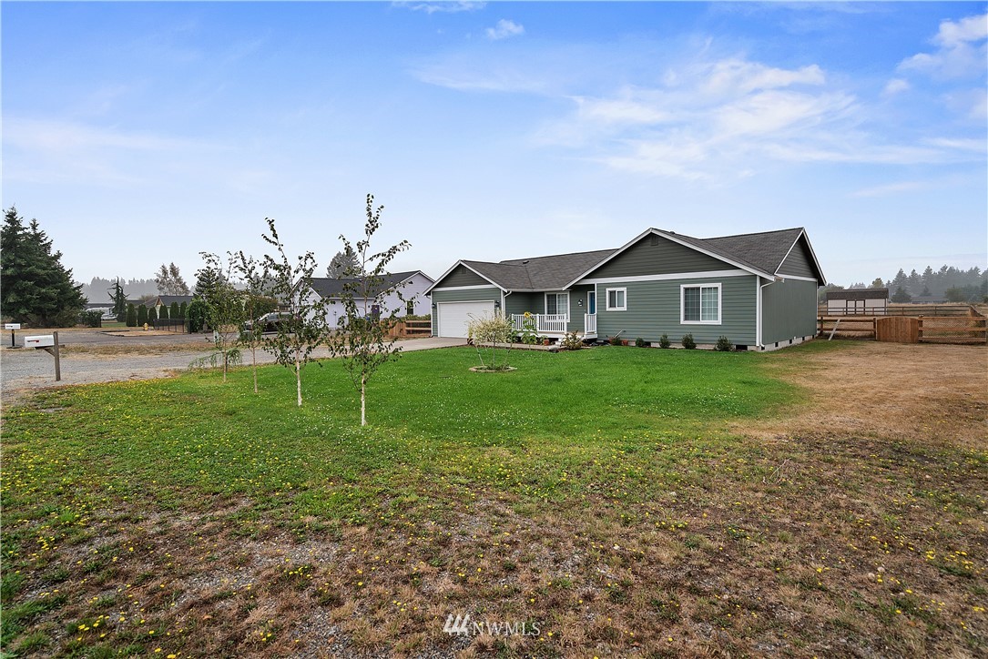 18011 Daryl Lane Southwest Rochester, WA 98579 - Photo 5 of 31 a front view of a house with a yard and trees