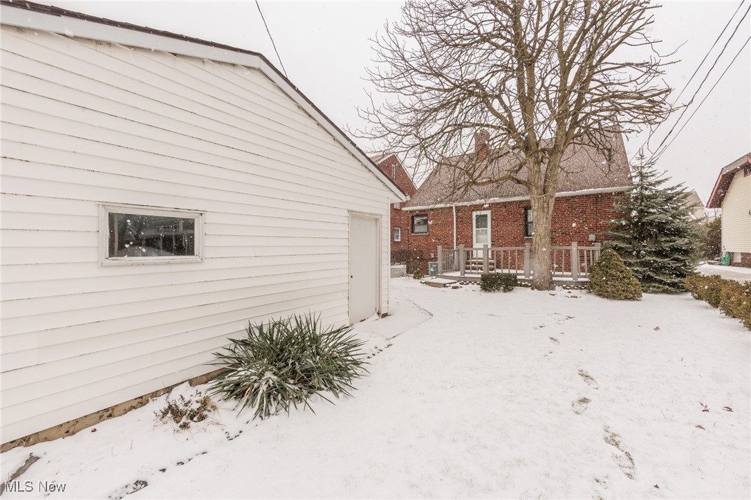 6192 Stanbury Road Parma, OH 44129 - Photo 5 of 49 Yard layered in snow with a wooden deck
