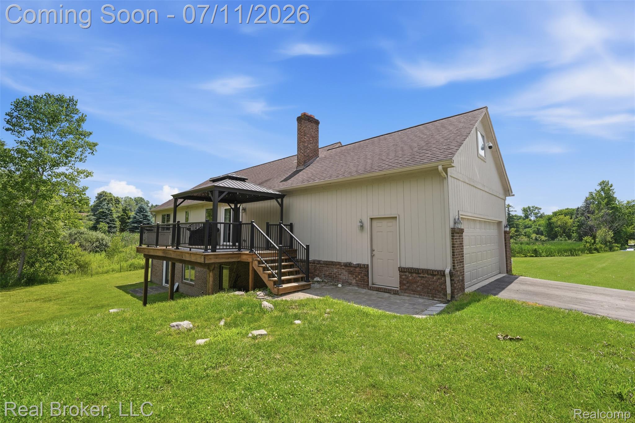 1050 West Brocker Road Metamora, MI 48455 - Photo 39 of 55 Exterior featuring a spacious deck with a black gazebo, wooden stairs, and dark railings