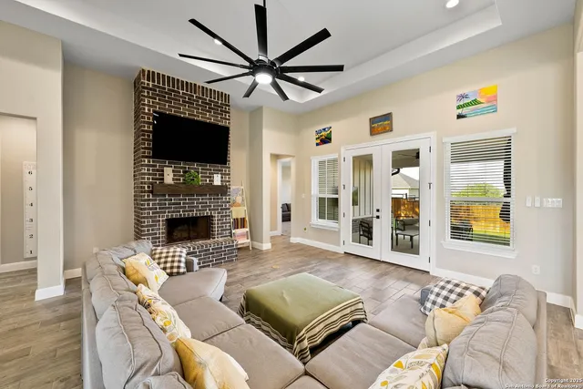 a living room with furniture a flat screen tv and a fireplace