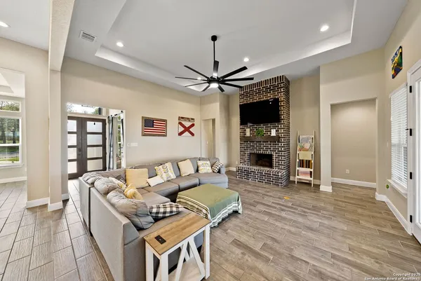 a living room with furniture a fireplace and a flat screen tv