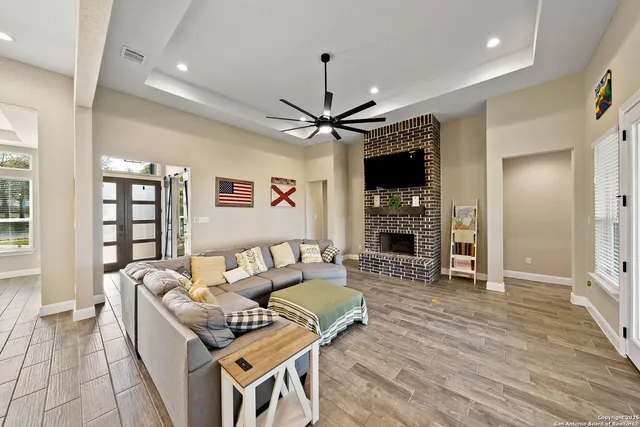a living room with furniture a fireplace and a flat screen tv