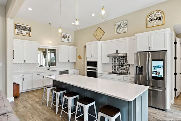 a large kitchen with a table and chairs