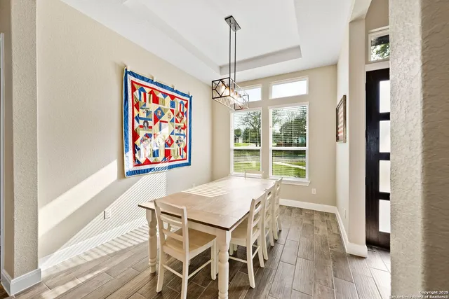 a view of a dining room with furniture window and wooden floor