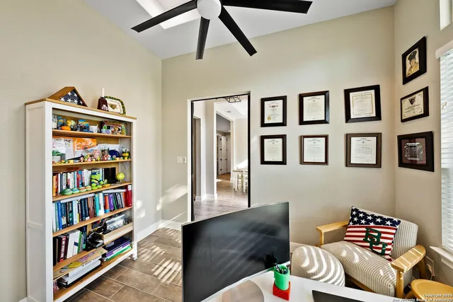 a living room with furniture and a book shelf