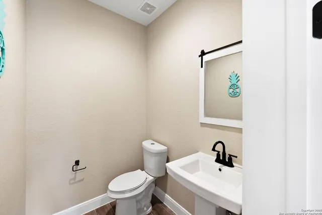 a white toilet sitting next to a bathroom sink