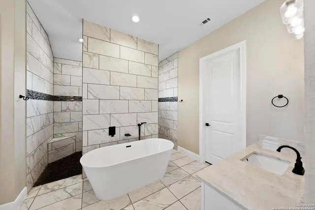 a bathroom with a bathtub and shower