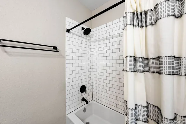 a bathroom with a bathtub and shower