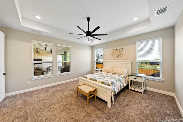 a bedroom with a bed and a window with a chandelier