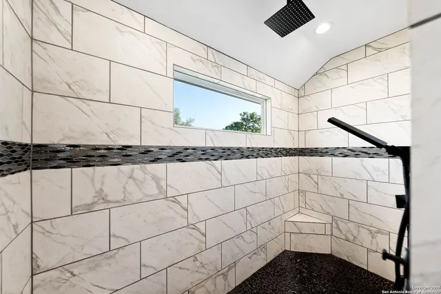 a bathroom with a shower and a window