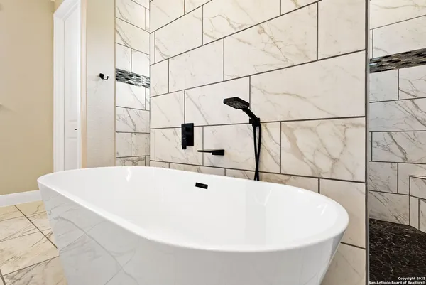 a white bath tub sitting in a bathroom