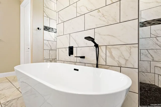 a white bath tub sitting in a bathroom