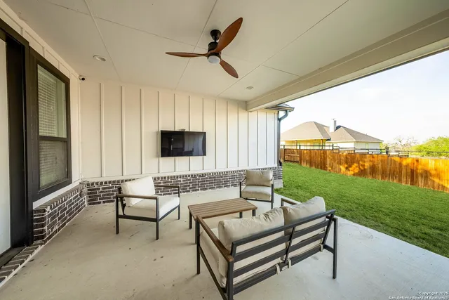 a view of a porch with furniture and a yard