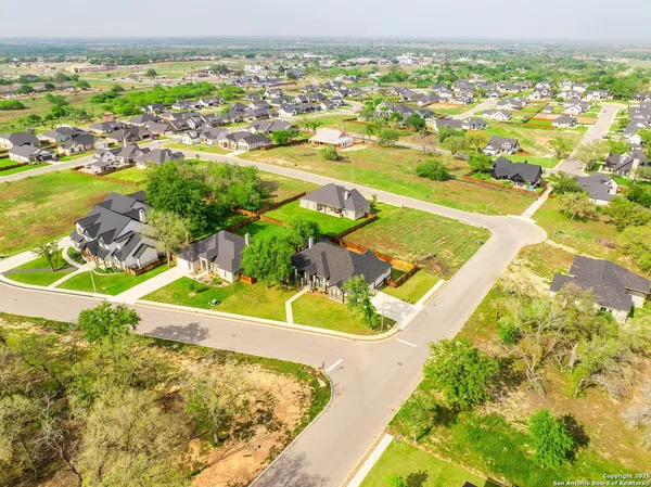an aerial view of residential houses with outdoor space