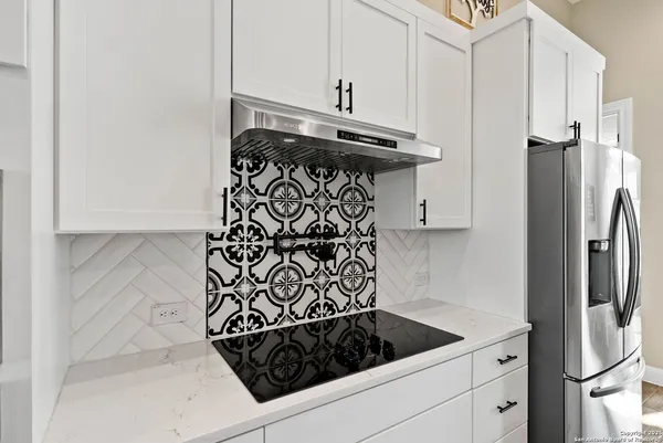 a kitchen with a refrigerator and a stove