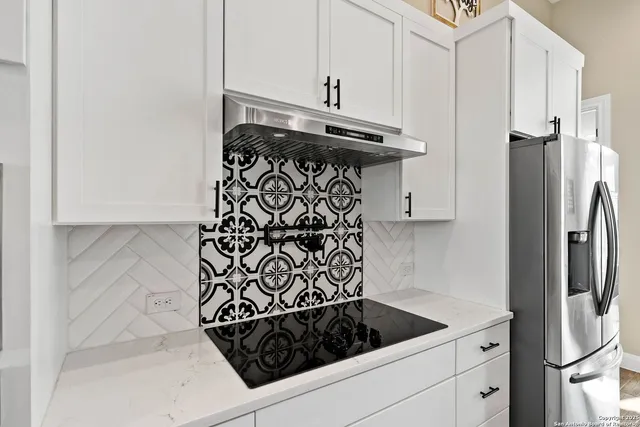 a kitchen with a refrigerator and a stove