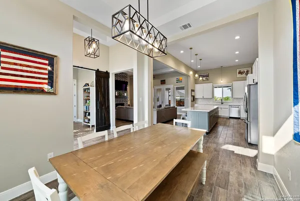 a large kitchen with a table and chairs