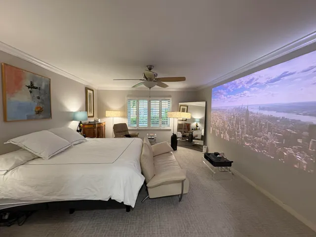 a bed room with a bed mirror and a large window