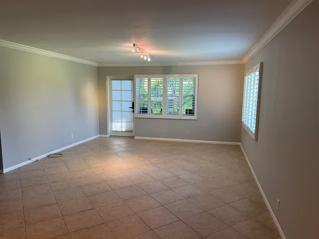 an empty room with windows and entrance