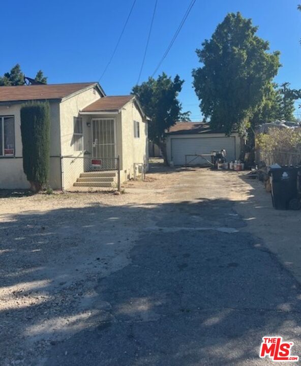 13678 Filmore Street Pacoima, CA 91331 - Photo 5 of 6 a front view of a house with a yard