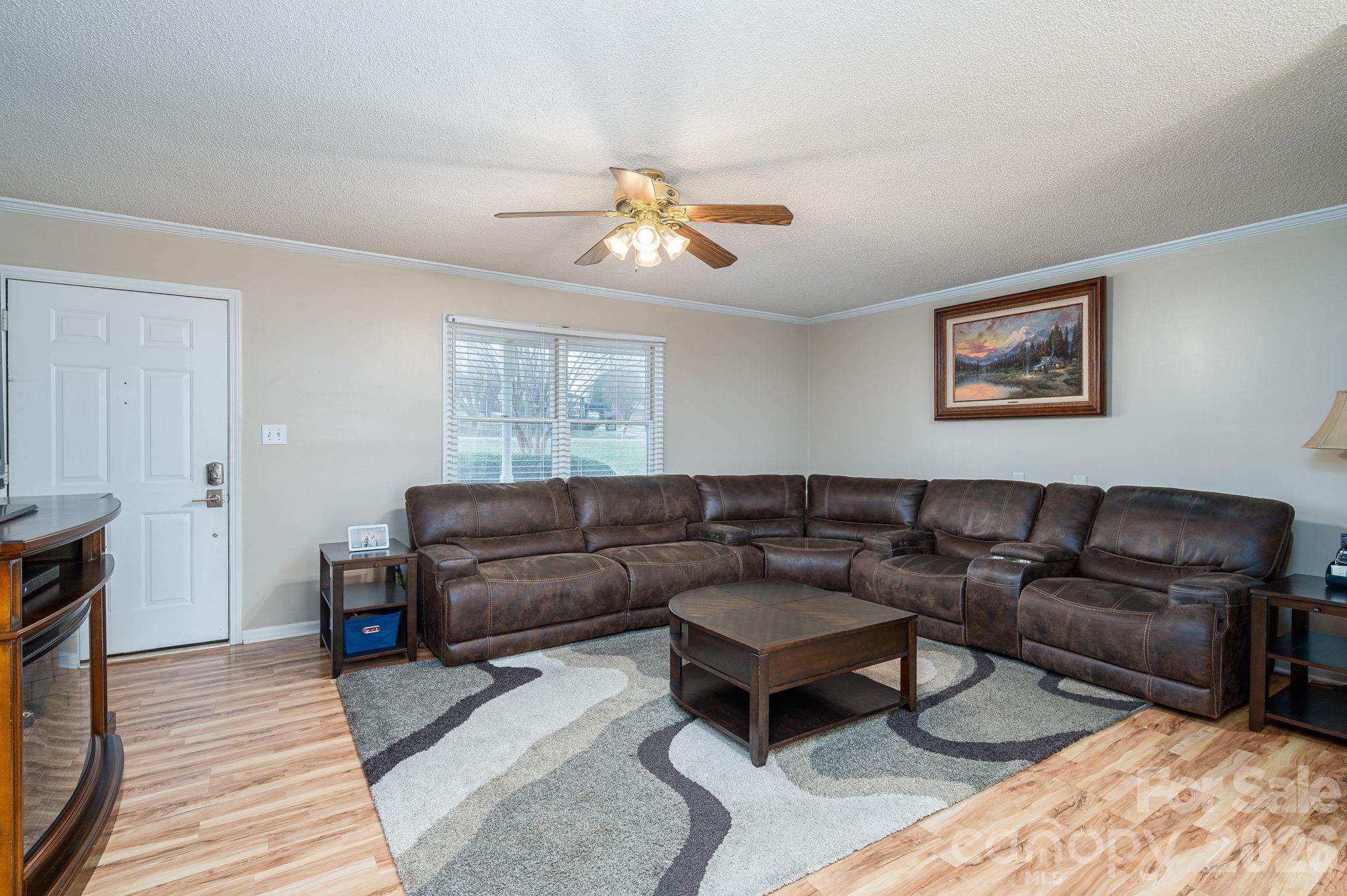 112 Pilots Ridge Drive Bessemer City, NC 28016 - Photo 20 of 36 a living room with furniture a couch and wooden floor