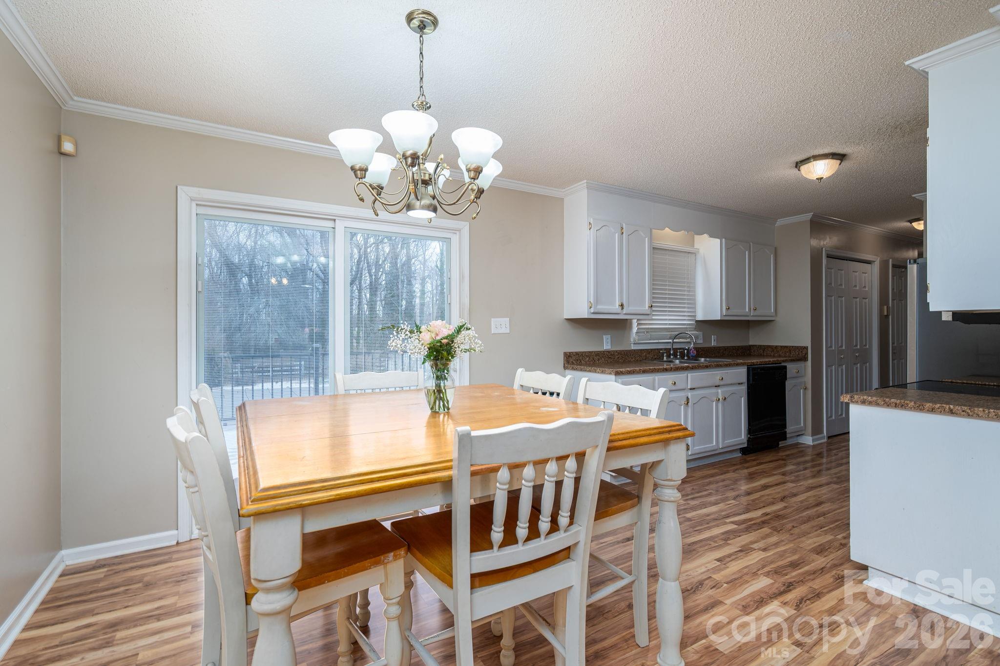 112 Pilots Ridge Drive Bessemer City, NC 28016 - Photo 23 of 36 a dining room filled chandelier and wooden floor