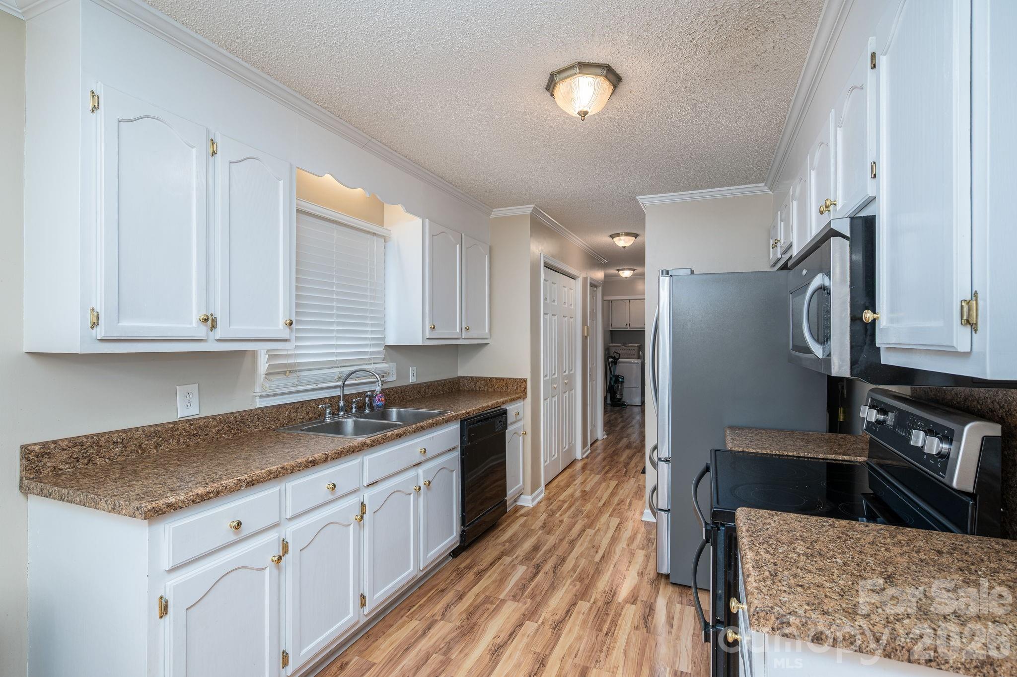 112 Pilots Ridge Drive Bessemer City, NC 28016 - Photo 24 of 36 a kitchen with granite countertop a sink a counter space appliances and cabinets